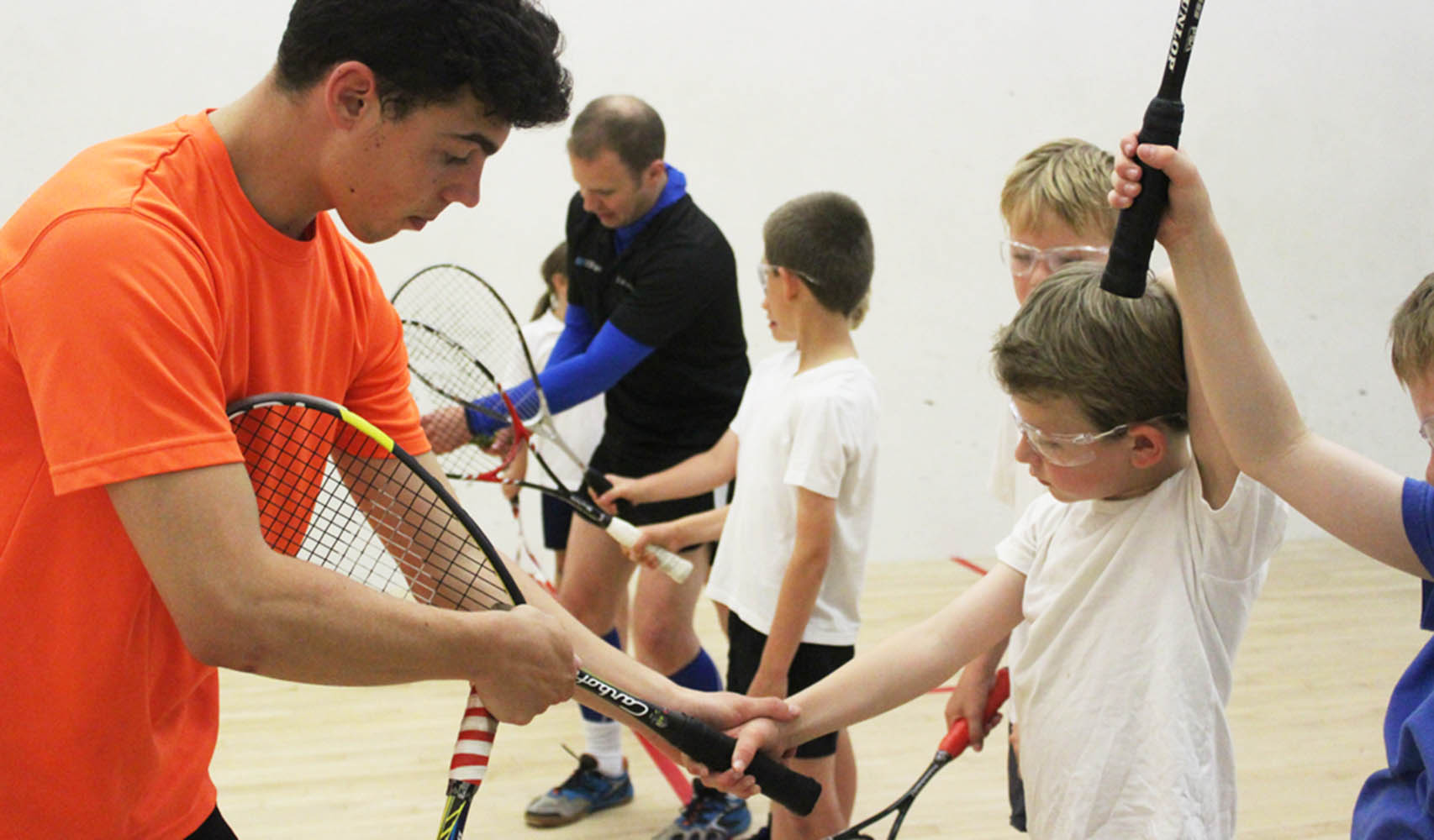 Coach leading a squash session to school children