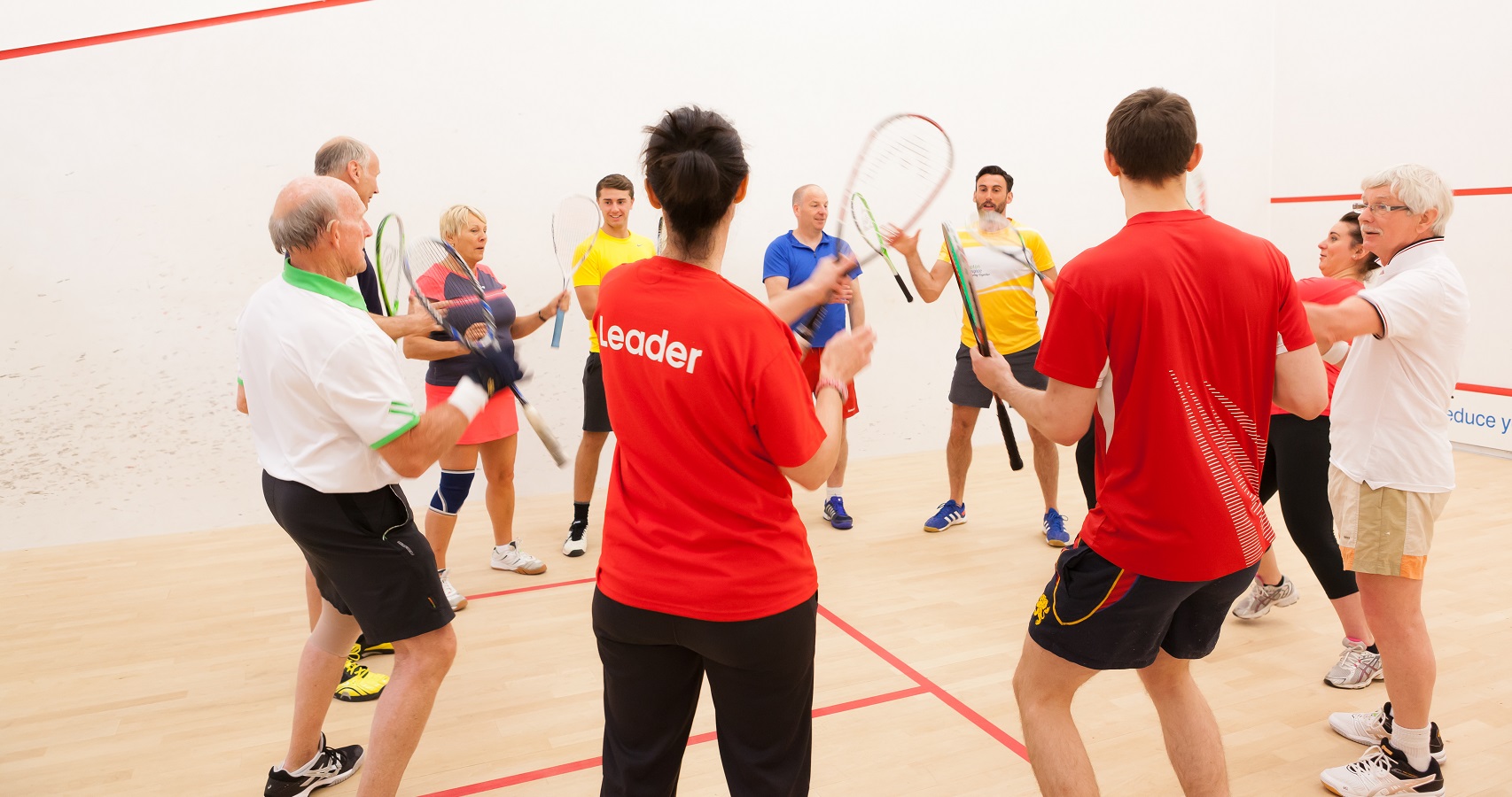 Group of squash players on court together 