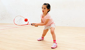 Young child  playing squash
