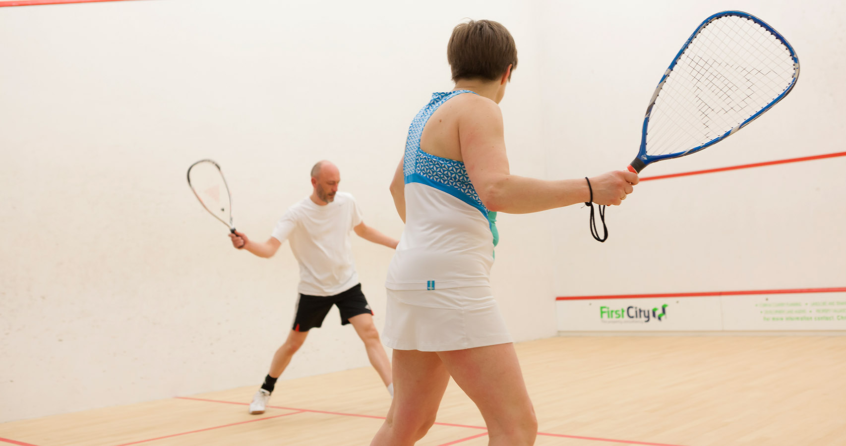 Squash 57 players playing on a squash court