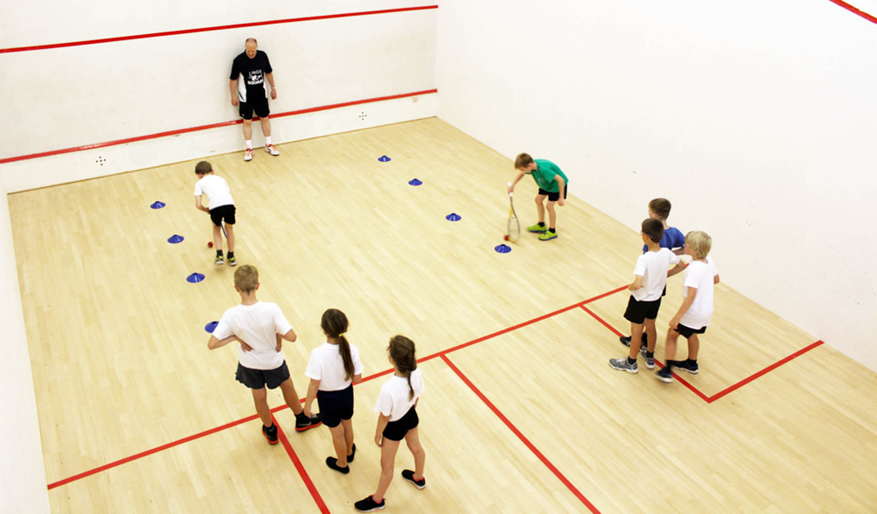 Group of school children playing squash