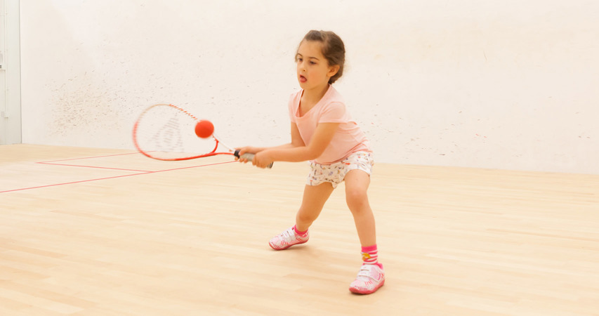 Young child playing squash