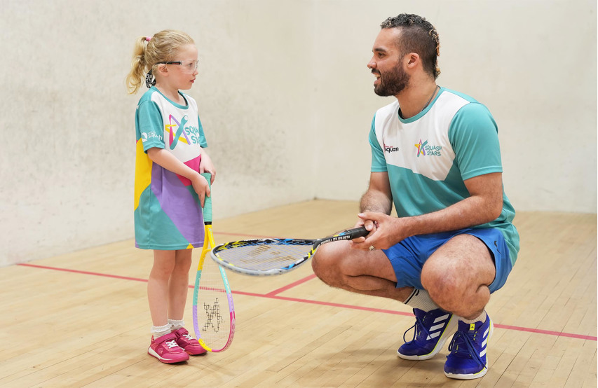 A coach leading a Squash Stars session