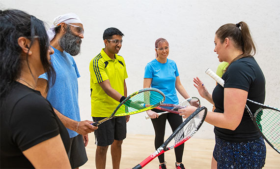 Female Coach Leading a squash Session