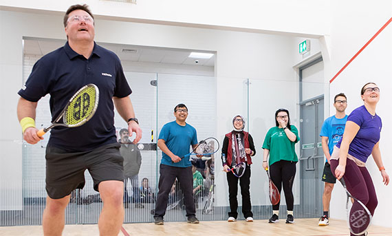 Male Squash Player in a group