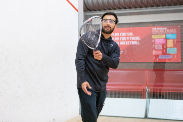 Man playing squash 57 on a squash court