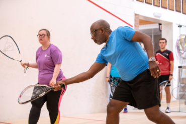 Woman and man playing squash 57