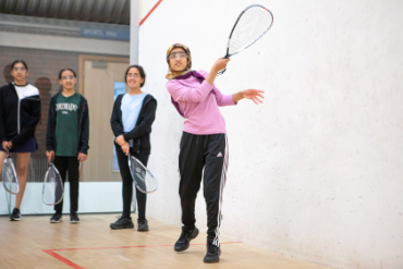Young women playing squash 57