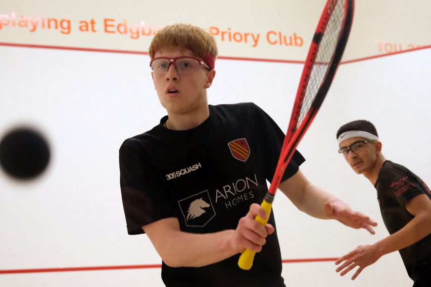 Male junior squash player Finnlay Withington on court