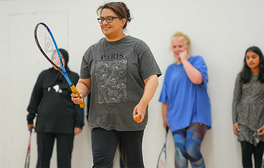A group of players on a squash court