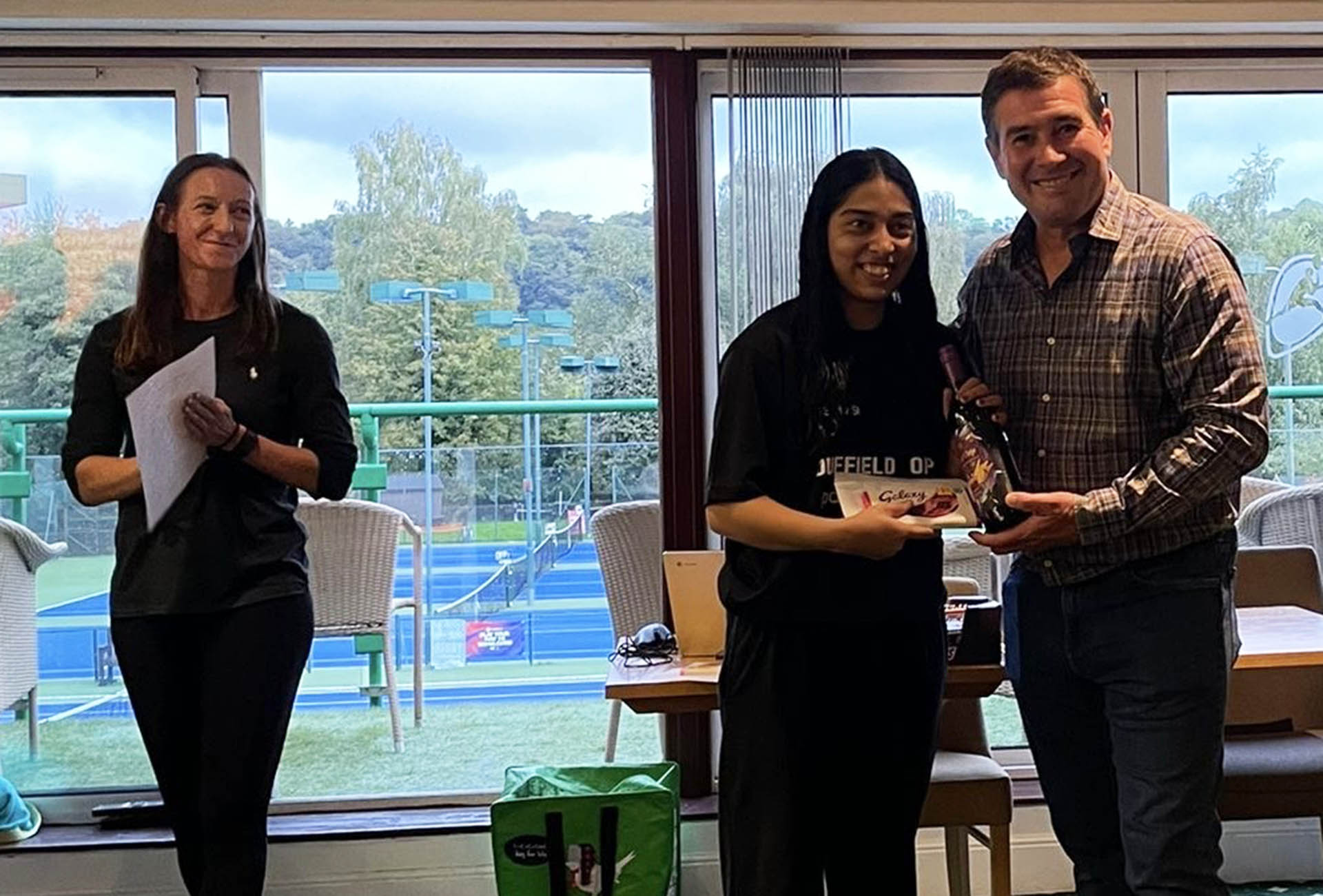 A winner of the Graded Tour receiving her prize