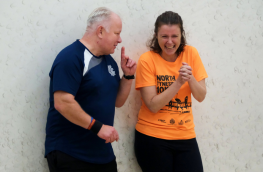 Two Individuals Speaking on a squash court