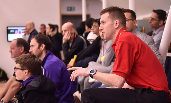 A squash referee officiating a game