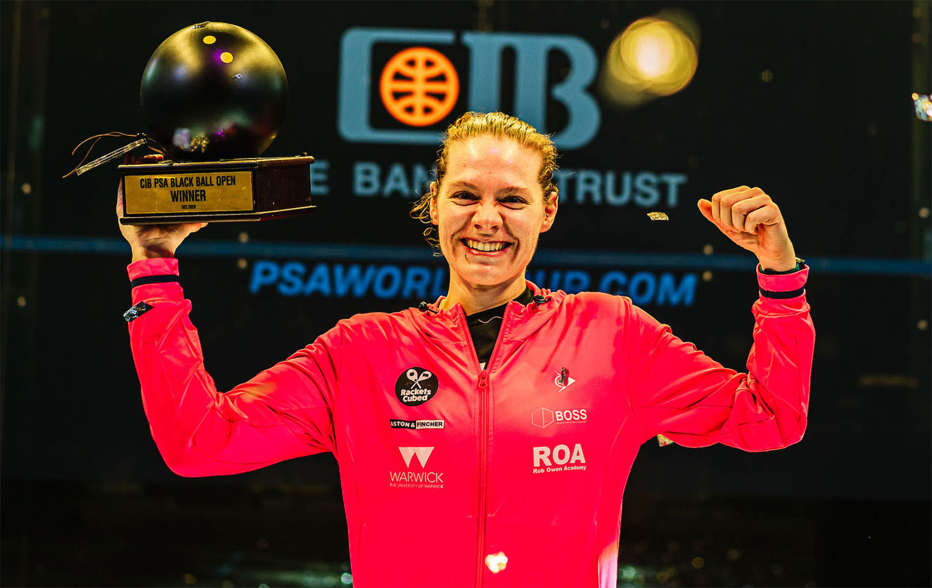 Squash player Sarah-Jane Perry lifts the Black Ball Open title