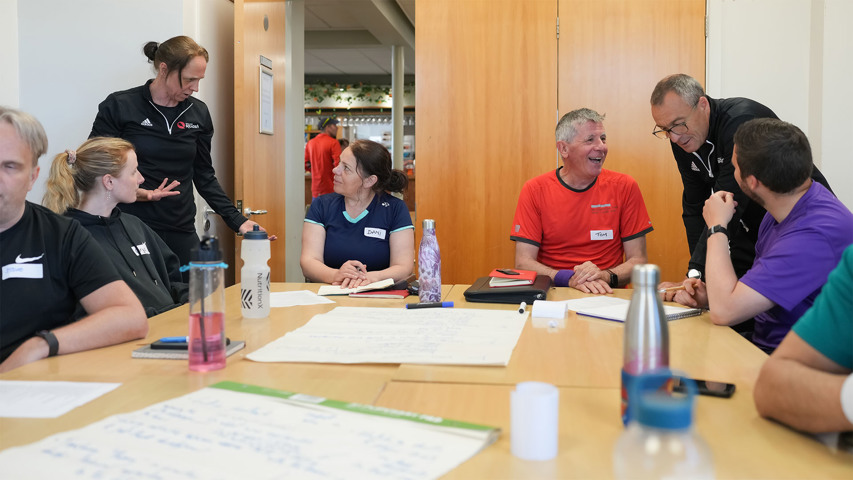 A squash tutor delivering a course