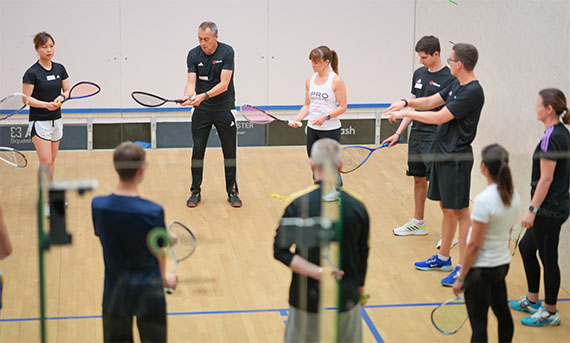 A squash tutor leading an England Squash course
