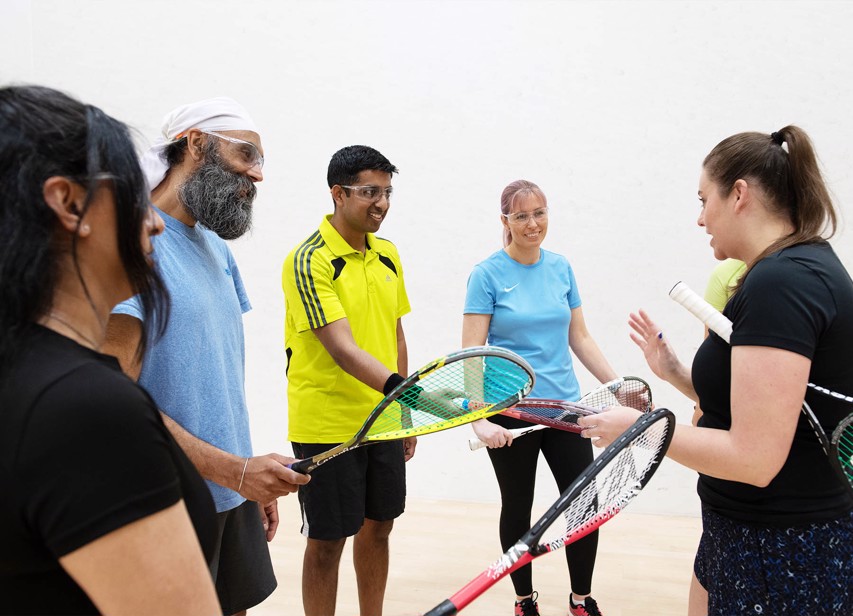 Squash players talking together on a squash court