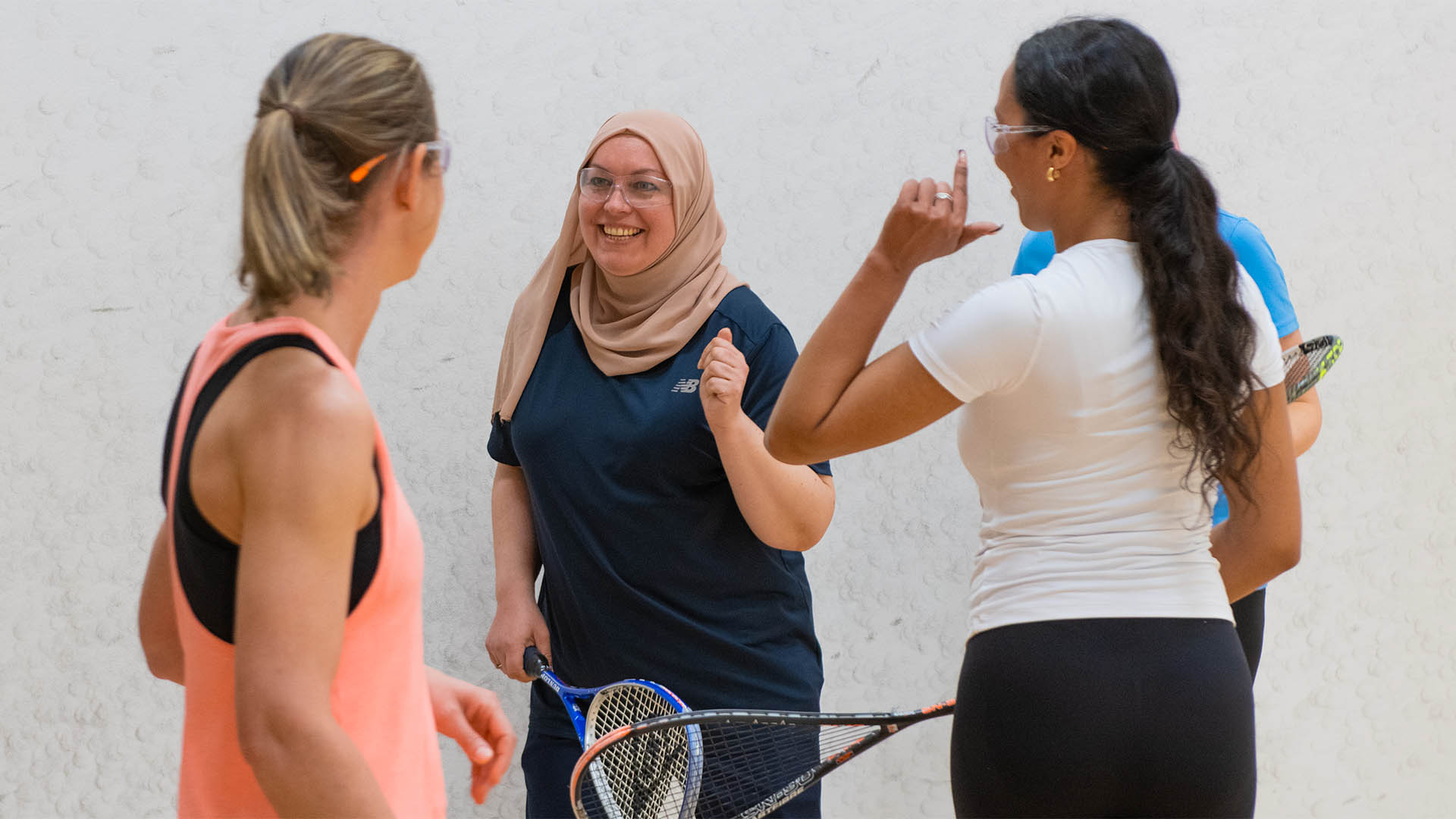 Women chatting on a squash court
