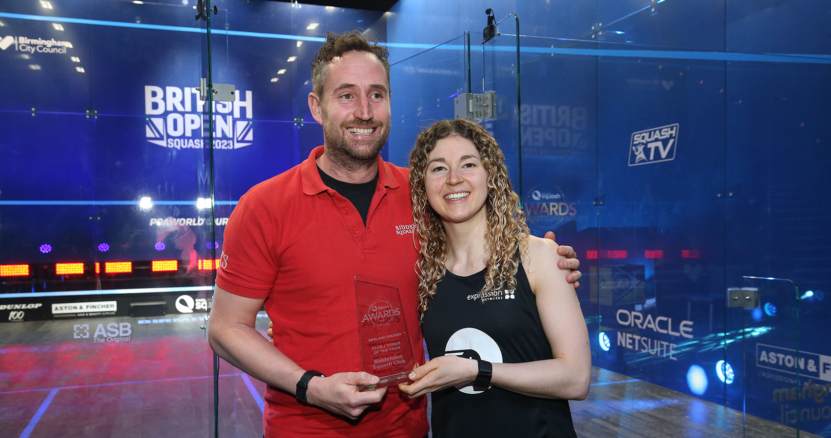 Biddenden Squash Club Head Coach Tom Swain is presented with the 2022 Club of the Year Award by England's Gina Kennedy.