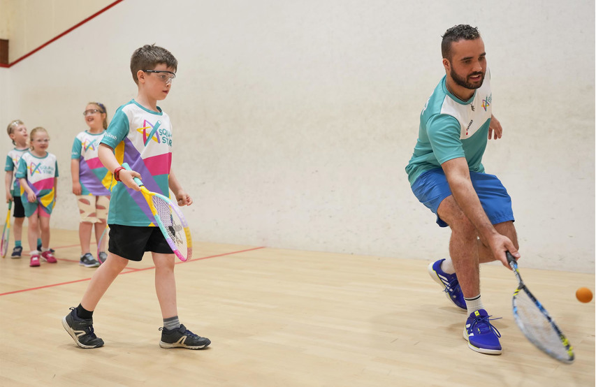 A coach leading a Squash Stars session