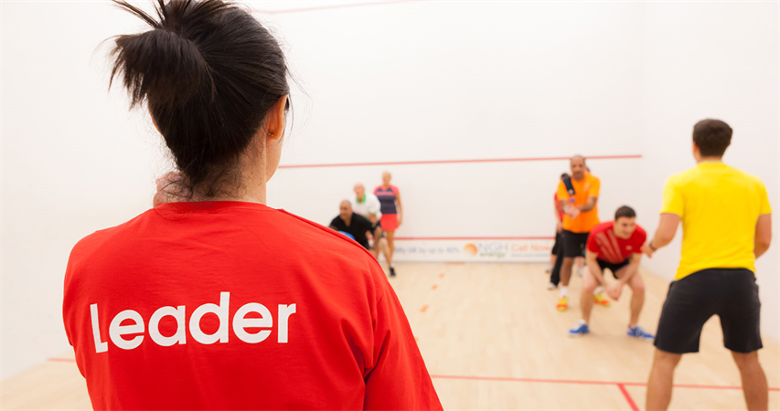 Group of squash players on court