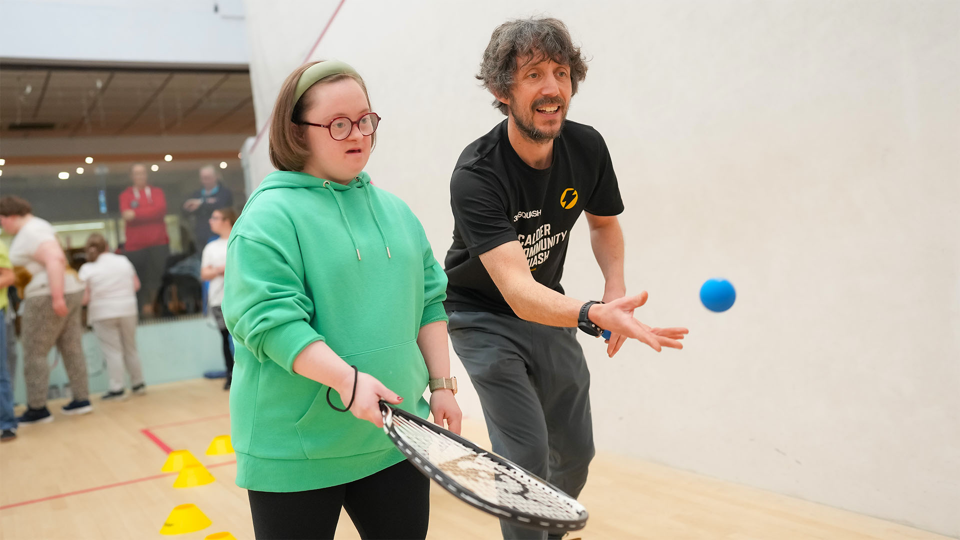 A squash coach leading a Mixed Ability session